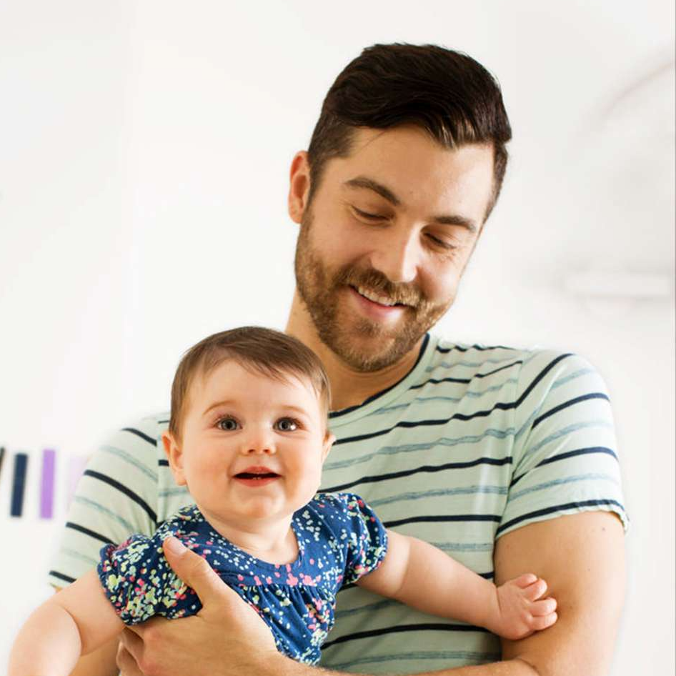 Parent holding baby in a nursery setting